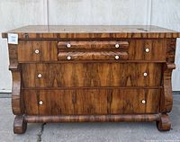 Front view of three-drawer walnut veneer dresser with porcelain knob pulls