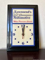 Front view of vintage Townsend's Automotive wall clock showing full clock face and branding.