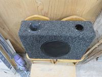 View of the front and top surface showing the 8" subwoofer speaker, tweeter, port hole, and carpet covering.