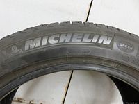 Close-up of Michelin brand name and tire sidewall showing branding and tire type.
