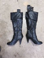 Photo of both boots standing upright showing front and side views, highlighting fold-over cuff and zipper.