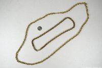 Two gold-tone chains displayed flat with a quarter for size reference on a white background.