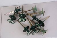 Multiple garden hose guards on a white surface showing their different styles and conditions.