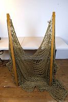 Full front view of the Nags Head hammock with its woven rope netting and wooden frame supports on both sides.