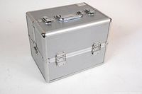 Closed silver aluminum Caboodle travel box with handle and latches.