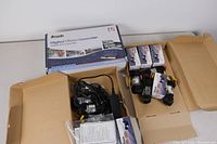 Overview image showing boxed digital video recorder and multiple CCTV cameras with cables.