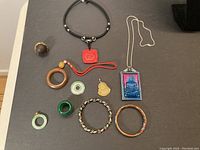 Full lot with oriental themed jewelry on black background, showing all pieces