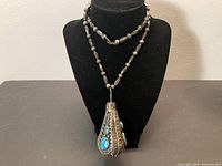 Full view of necklace displayed on black bust