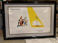 Full view of framed wall art showing Looney Tunes characters and empty microphone under spotlight, titled 'Speechless'.