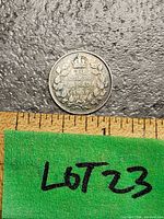 Reverse of 1936 silver Canadian dime showing denomination and maple leaf wreath with measuring scale below.