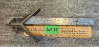 Antique L.S.S. Co ruler with center finding head shown on top of paper ruler.