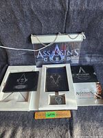 Collection displayed including the lighted sign, books, belt buckle, and packaging.