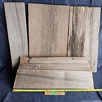 Group of 6 weathered barn boards with visible wood grain and wear showing.