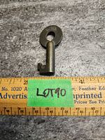 Photo of vintage brass CNR railroad key placed above a wooden ruler for scale, showing key length about 2.5 inches.