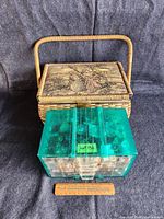 Photo of the vintage wicker sewing basket with a decorative lid and handle.