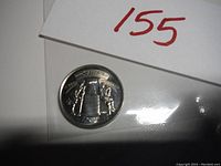 Photo of silver commemorative coin featuring the Stanley Cup and two hockey players with the years 1892-2017.