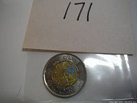 Front view of the colored twoonie coin displaying the inscription 'Discovery of Insulin 1921' and colored details in blue and gold tone.