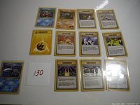 12 early Pokemon cards showing different Trainer and Energy cards, plus a Shellder Pokemon card.