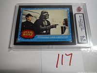 Front view of 1977 Star Wars trading card #10 Princess Leia Captured in plastic sleeve with 6.5 ENM+ grade label visible.