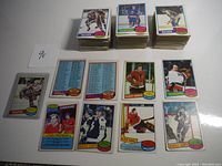 Partial set cards arranged in stacks, various player cards laid out flat showing front and back with team checklists and players from Blues, Islanders, Canadiens, Maple Leafs, Black Hawks.