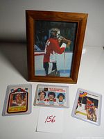Overall view including framed photo and two dealer hockey cards.