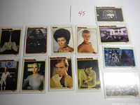 Photo showing multiple Star Trek trading cards laid flat including key characters like Uhura and scenes.