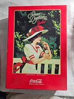 Outer box featuring illustration of the Summer Daydreams Barbie wearing white and red with a hat and drinking a Coca Cola, captioned as part of Coca Cola Fashion Classic Series.
