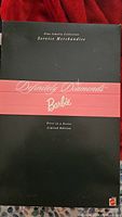 Front view of the black box packaging labeled 'Definitely Diamonds Barbie' with indication of limited edition series.