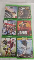 Six Xbox One game cases arranged in two columns of three. Visible titles: Forza Horizon 3, NBA 2K15, Battleborn, Red Dead Redemption II, FIFA 15, Star Wars Battlefront.