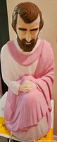 Front view of the vintage blow mold Joseph statue showing the painted facial features, hair, and pink and white robe.