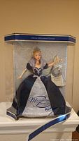 Full view of Vintage Millennium Princess Barbie doll in the original packaging with blue and silver design, showing 'Official Millennium Edition' text at the top and 'Millennium Princess' on the front of the gown.