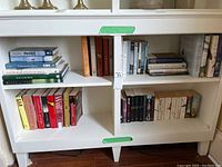 Books arranged on bookshelf showing bird-related books and novels