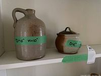 Jug and lidded dish side by side on shelf with labels showing dimensions