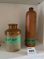 Photo of two stoneware crocks on shelf with a note indicating dimensions: 5" diameter by 7" height for the shorter one, and 3" diameter by 11" height for the taller one.