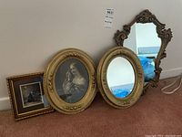 Four items shown leaning on a wall, including two framed prints and two ornate wall mirrors with gold-tinted frames.