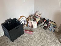 Wide view of entire lot showing yarn, knitting needles, patterns, embroidery hoops, and collapsible box.