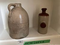 Wide view showing both jug and hot water bottle side by side, indicating approximate sizes and appearance.