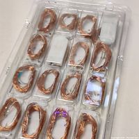 Packed set of 16 fairy string light coils with attached battery packs in clear plastic blister packaging.