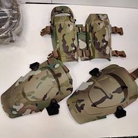 Front view of the three tactical accessory pieces laid out on a white surface showing detailed multicam pattern and strap buckles