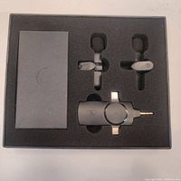 Overall set in custom foam packaging showing two lapel microphones, receiver, and a box compartment