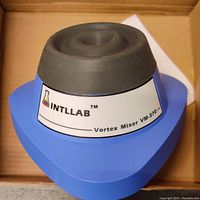 Side angle view of the INTLLAB VM-370 vortex mixer showing branding and black rubber cup for mixing tubes.