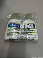 Two bottles of Cetaphil DailyAdvance Ultra Hydrating Lotion in sealed plastic packaging, front view showing label and warning.