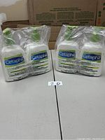 Photo of 4 Cetaphil lotion bottles sealed in plastic wrap, showing front labels.