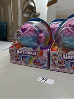 Four Hatchimals Family Coffret toy packs shown in original sealed packaging with colorful front and side details and heart-shaped capsules visible.
