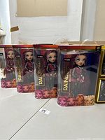 Front view of four boxed Rainbow High dolls showing the character Mila Berrymore, each in clear plastic and cardboard packaging.