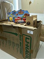 Photo showing a cardboard box with Spin Master Mighty Express motorized train toys in original packaging on top