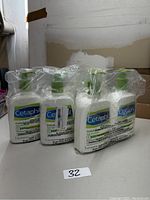 Six bottles of Cetaphil DailyAdvance Lotion 2.6 fl oz individually identified with pump tops, shrink-wrapped in packs of two.