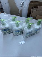 Six bottles of Cetaphil lotion in three sealed clear plastic packs of two bottles each, with green pump dispensers and Cetaphil labels.