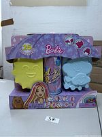 Front and side angled view of boxed Barbie Color Reveal doll set showing packaging, molds, and branding.