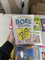 Front cover of 'Dork Diaries' showing a white cover with cartoon girl and title